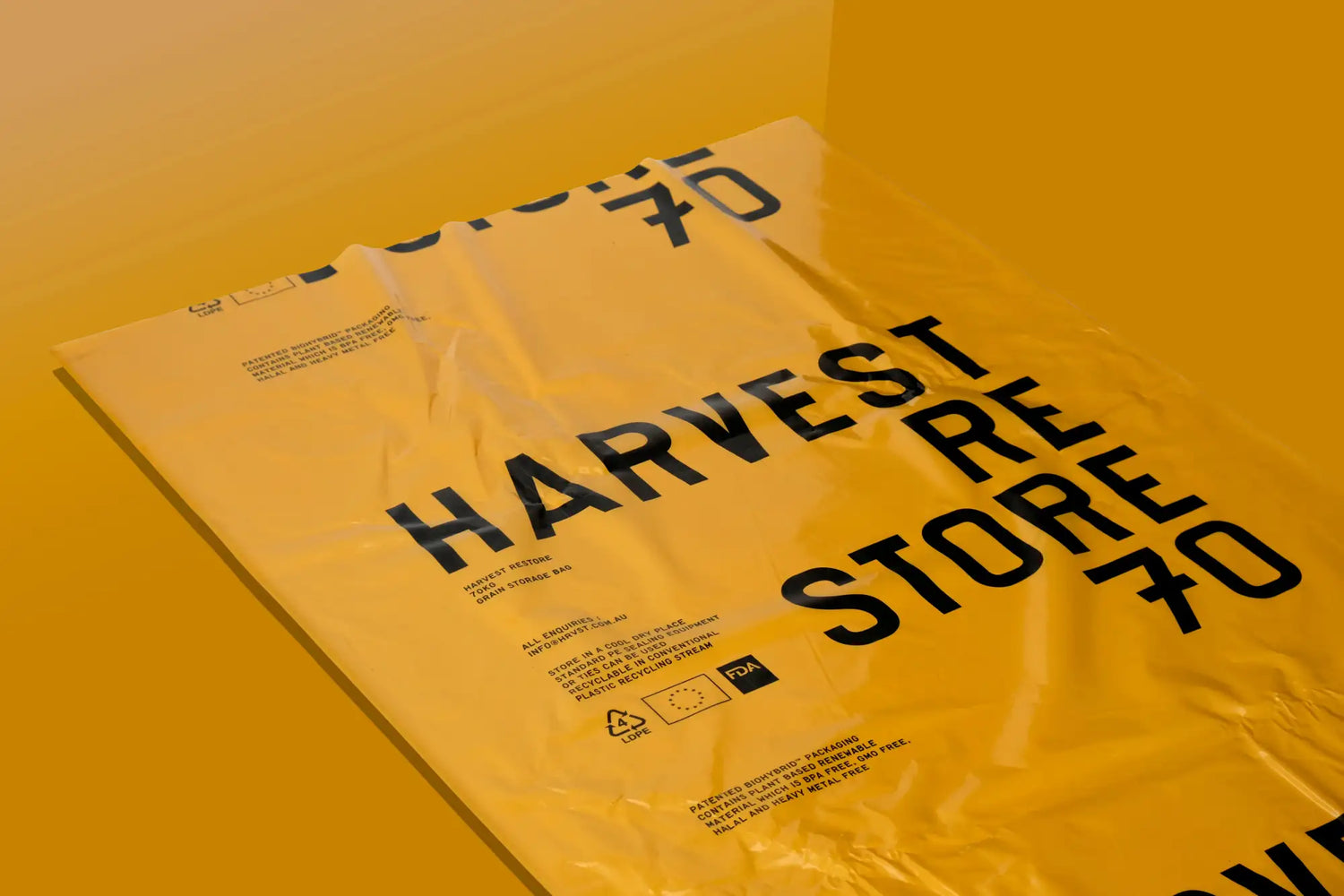 A crinkled yellow plastic bag with bold black text reading ’harvest store 70’’ and smaller print detailing product information.