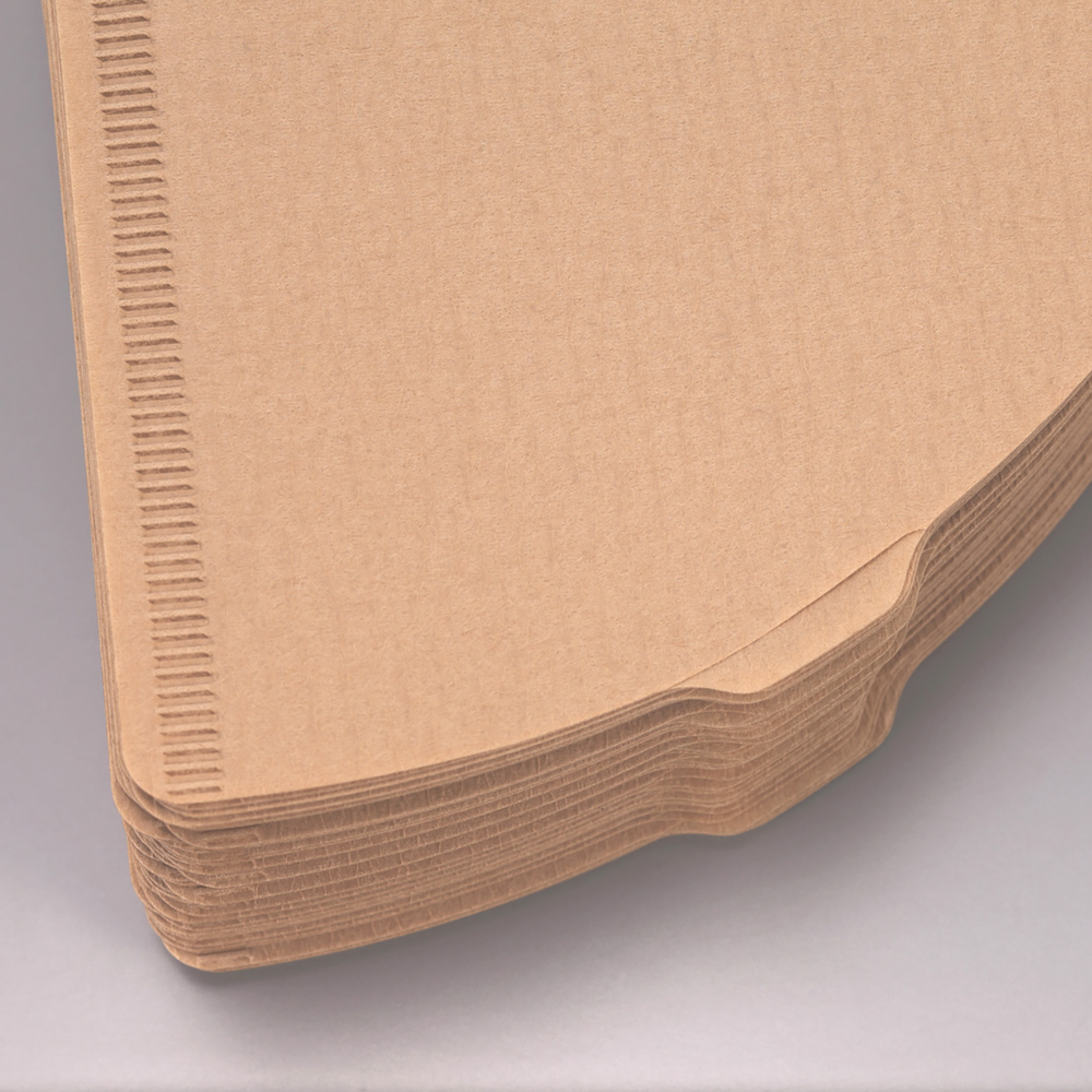 Stack of unbleached Hario V60 02 paper filters, close-up of the paper texture