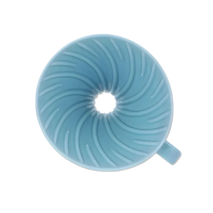 Top view inside the light blue Hario V60 ceramic dripper showing spiral ribs and large drip hole