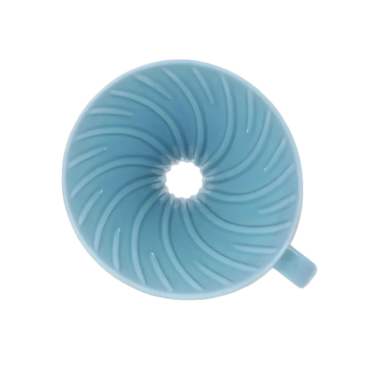Top view inside the light blue Hario V60 ceramic dripper showing spiral ribs and large drip hole