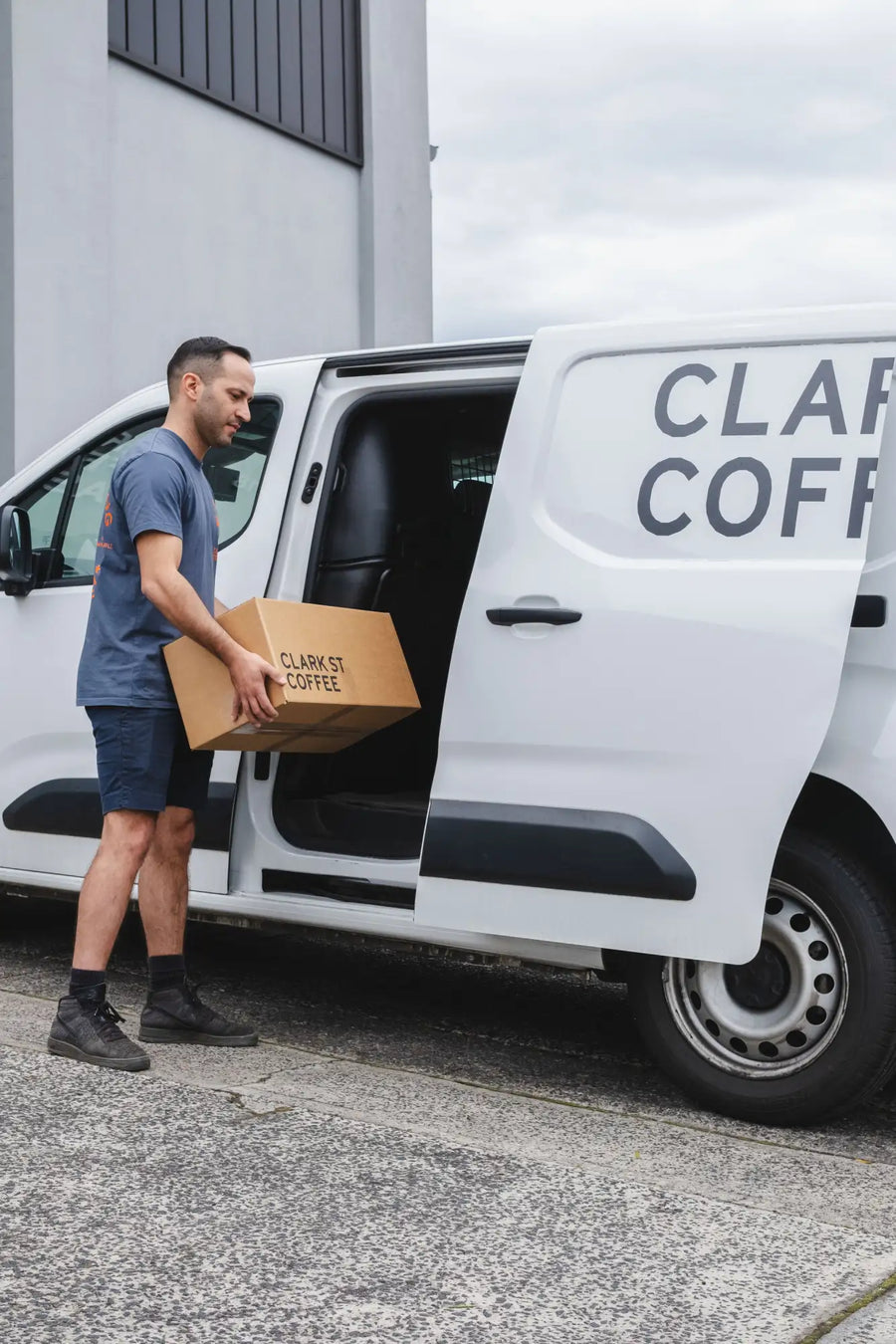White van with black trim and ’clark st coffee’ lettering on the side